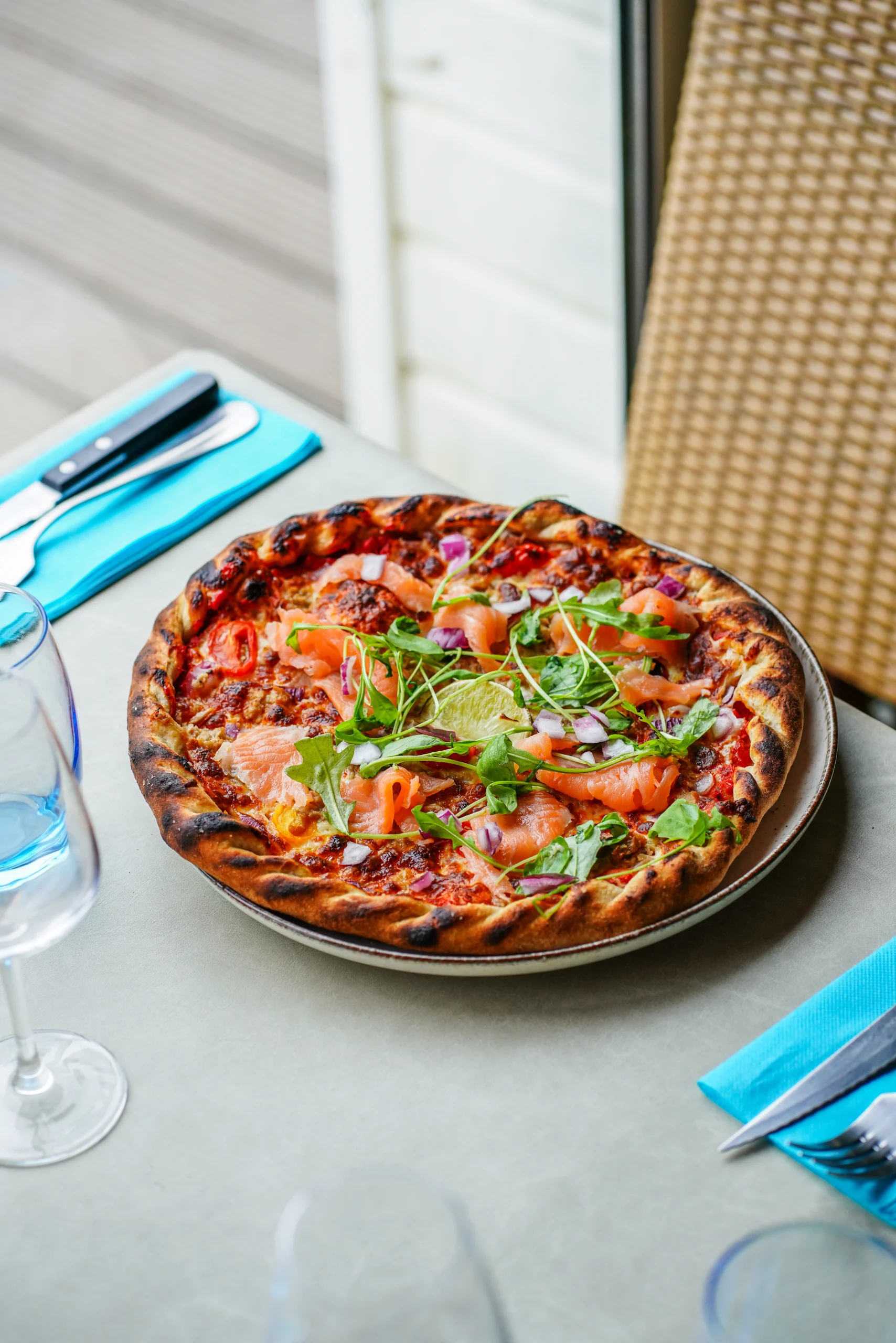 Pizza Del Mare avec saumon et roquette servie au Novoli